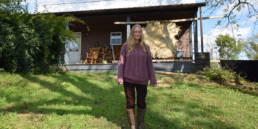 Christine McGuigan stands in front of her cabin in Fresno, Ohio