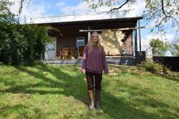 Christine McGuigan stands in front of her cabin in Fresno, Ohio